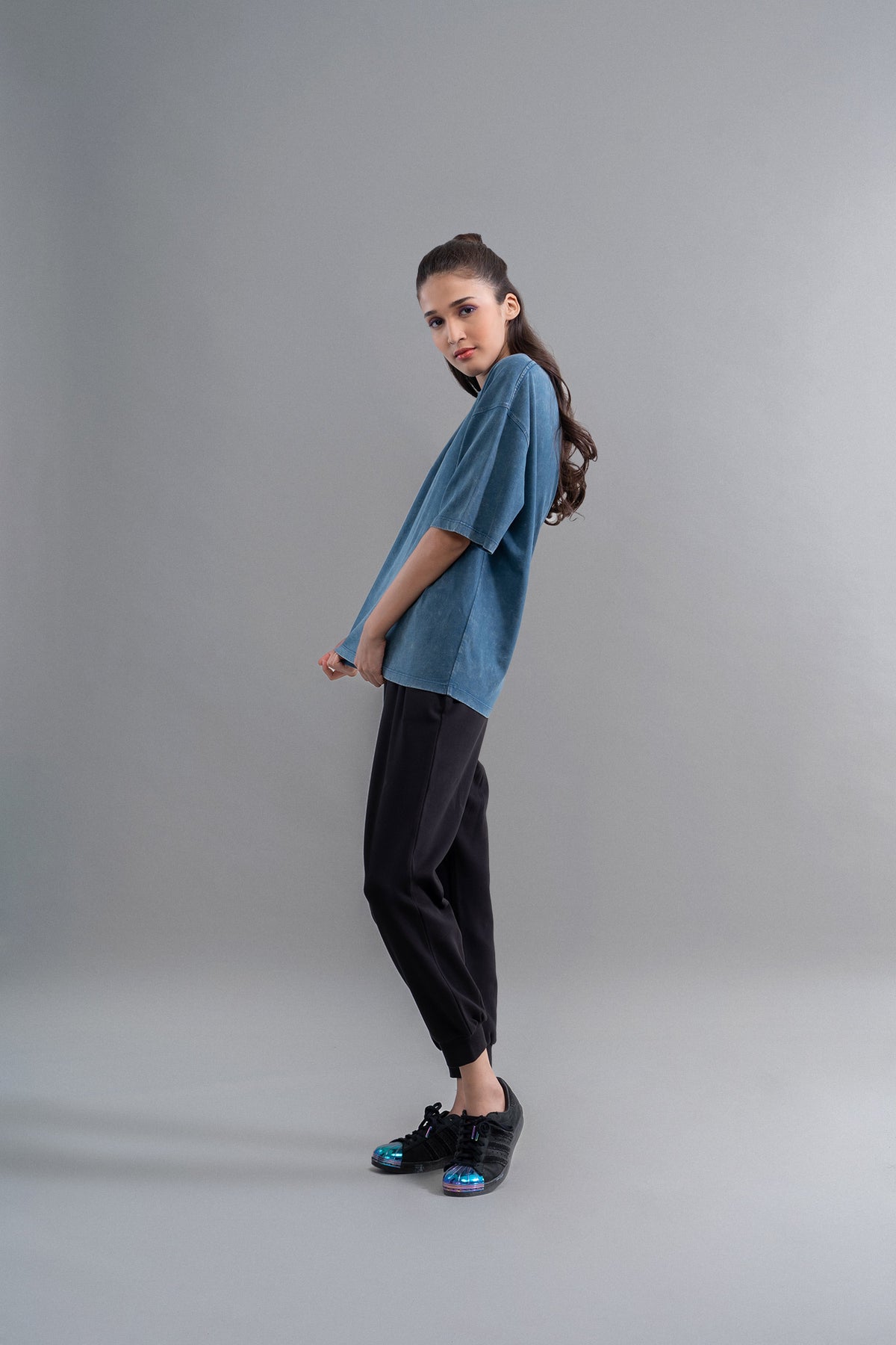 Teal acid wash unisex t-shirt styled with black pants and shoes.