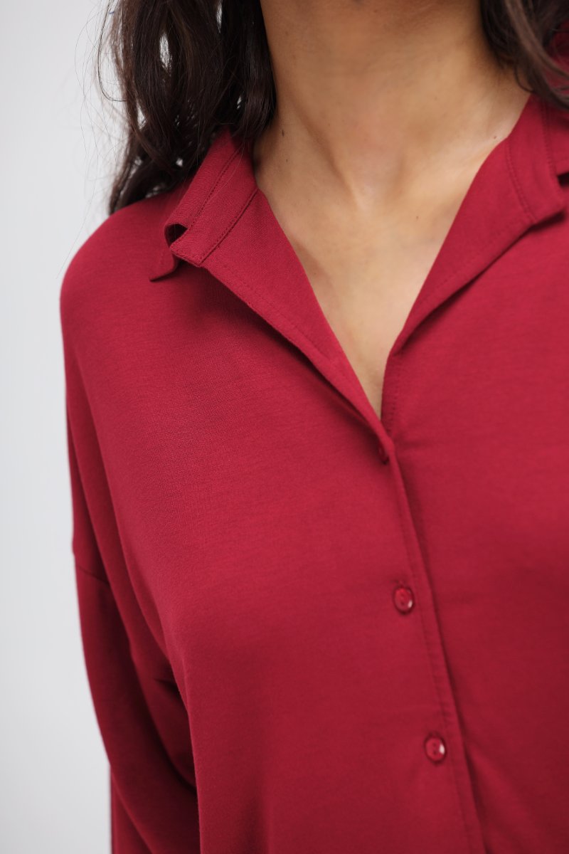 Romantic red button down shirt with stylish collar and buttons.