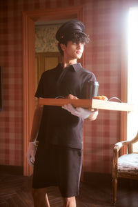 Lushknit® Mens Polo modeled by a young man serving coffee and pastries.