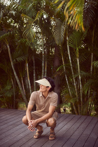 Tan Lushknit® Polo and Shorts Set modeled in tropical setting.