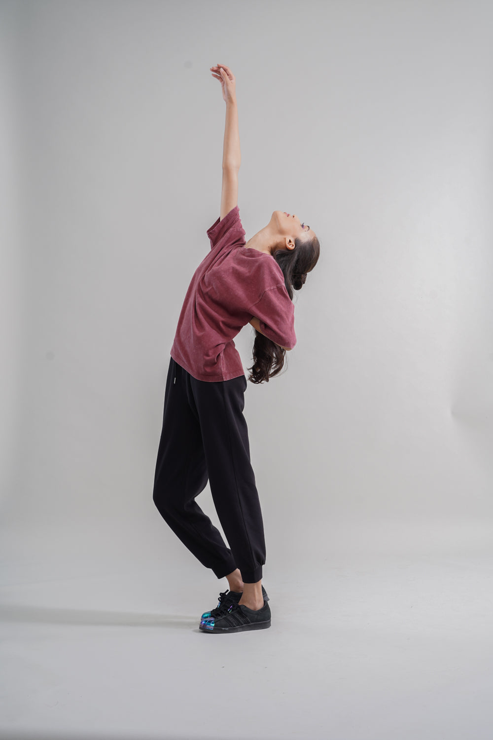 Rust acid wash unisex t-shirt worn by model in dynamic pose.