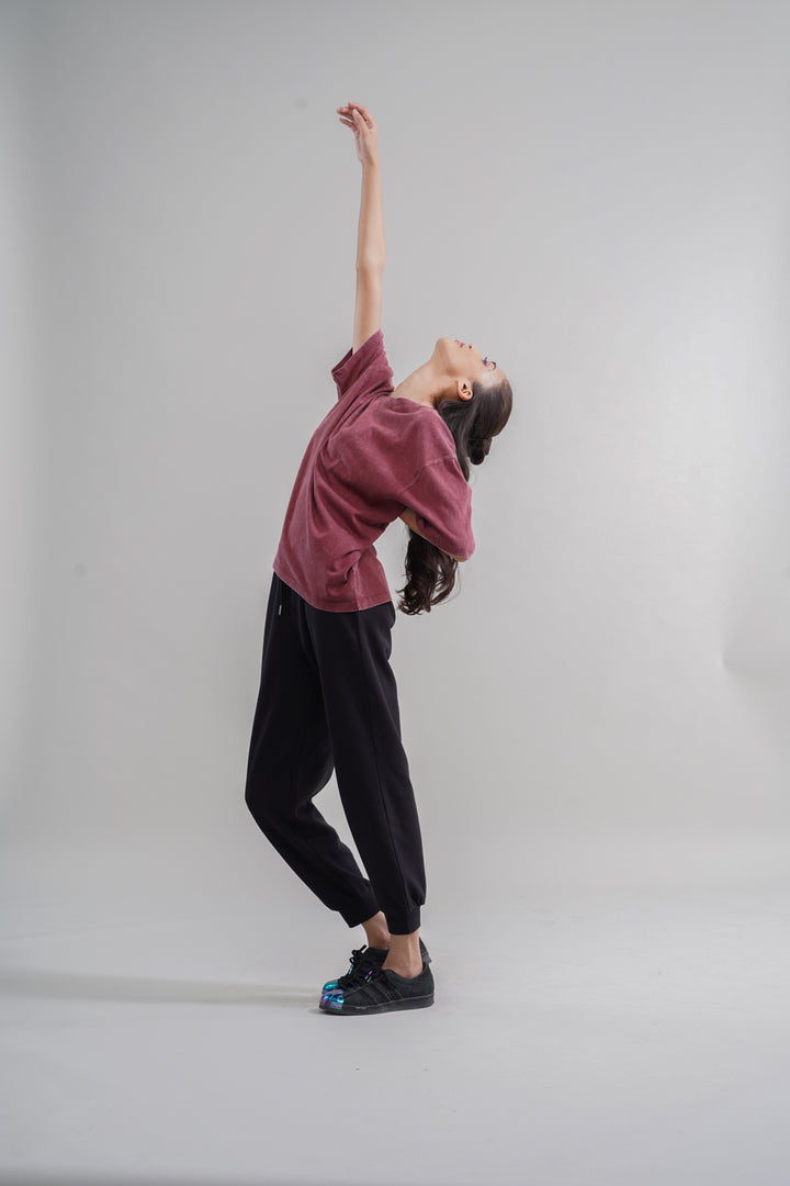 Rust acid wash unisex t-shirt worn by model in dynamic pose.