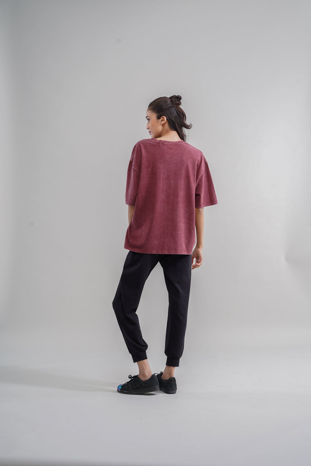 Rust acid wash unisex t-shirt displayed on model from the back.
