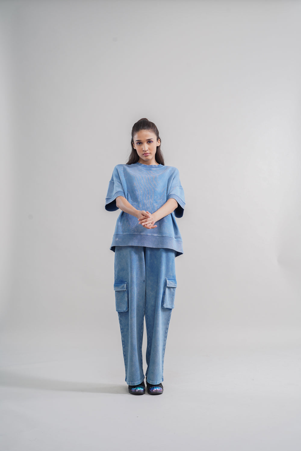 Model wearing denim wash 100% cotton terry sweatshirt and matching pants.