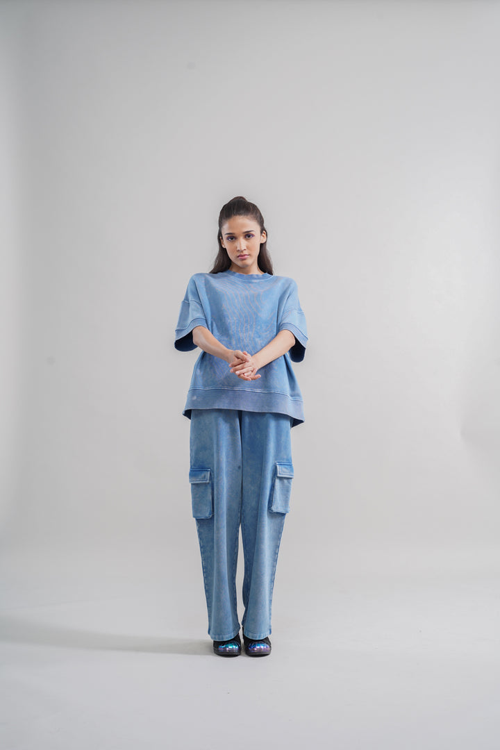 Model wearing denim wash 100% cotton terry sweatshirt and matching pants.