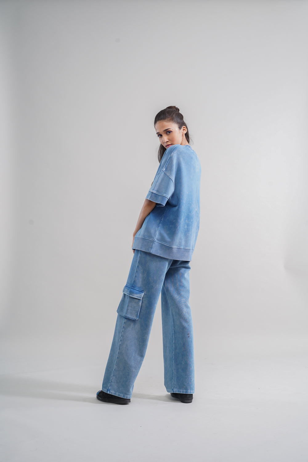 Denim wash 100% cotton terry sweatshirt on model in blue outfit.