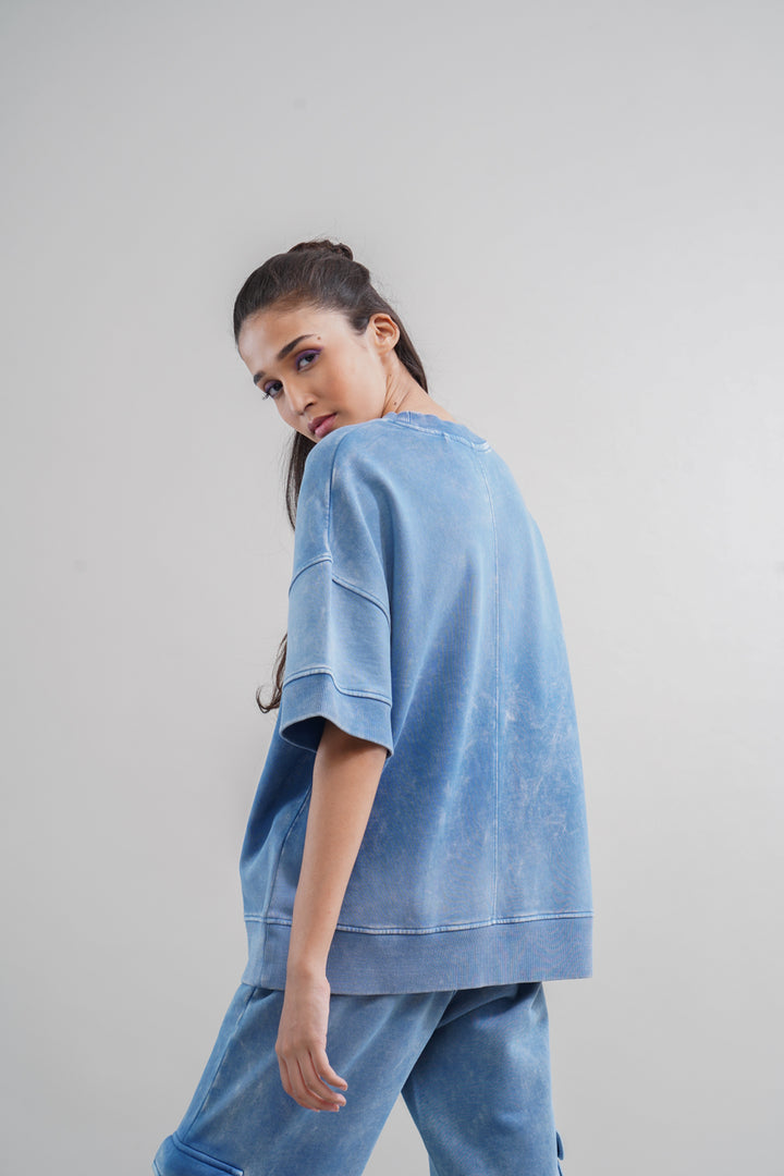 Model wearing denim wash 100% cotton terry sweatshirt, casual stylish look.