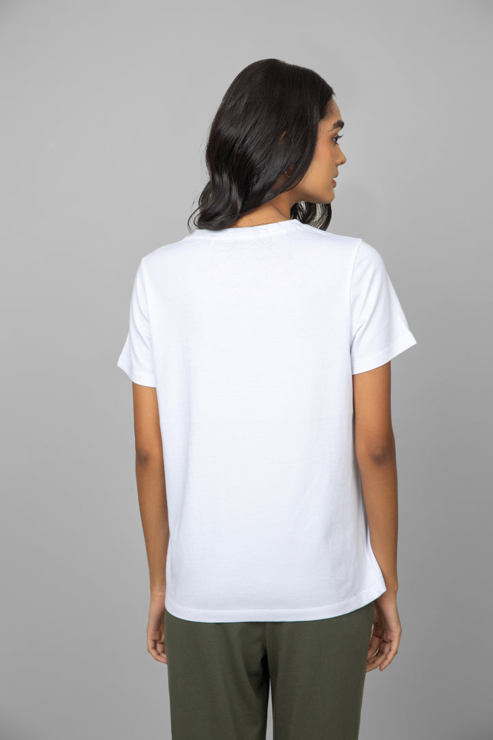 Model wearing a white V-neck shirt from the back.
