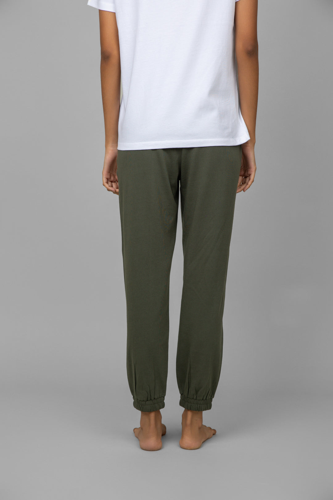 Back view of a model wearing a white V-neck jogger set.