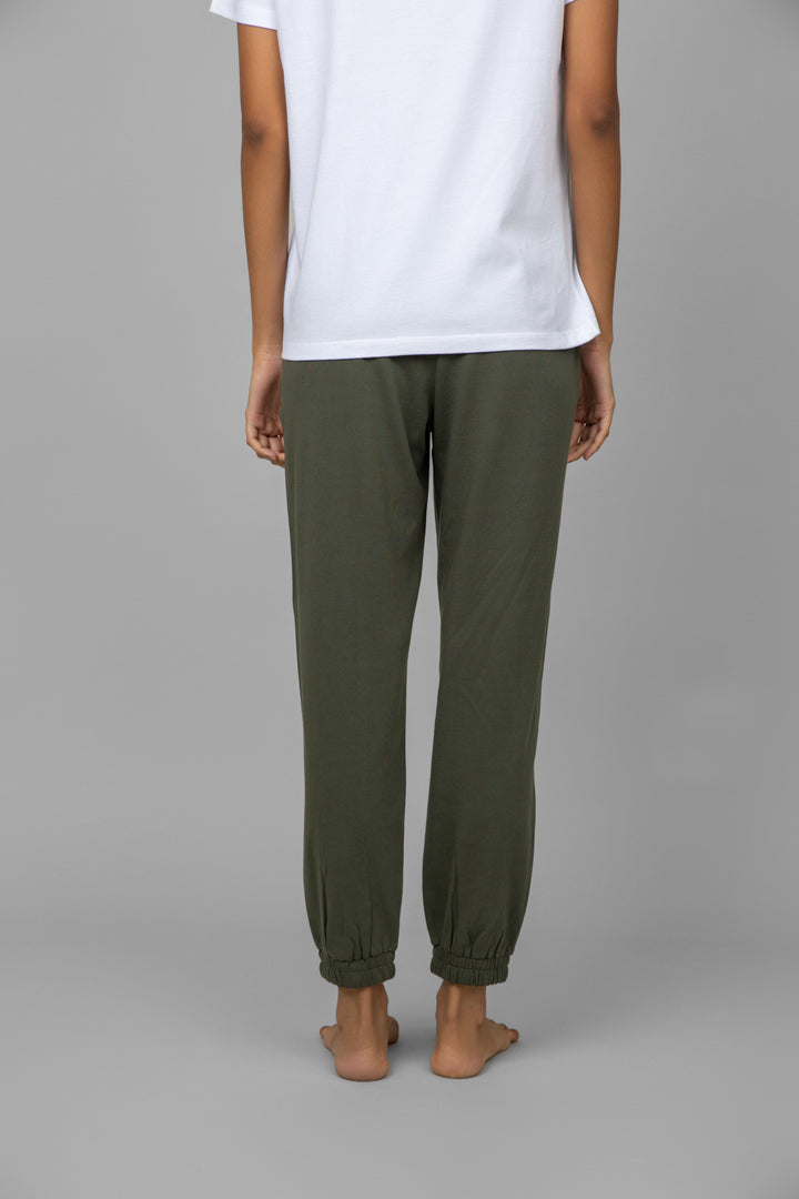 Back view of a model wearing a white V-neck jogger set.
