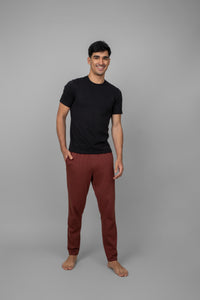 Rust men's jogger set with black t-shirt and stylish pants.