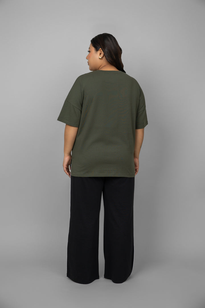Back view of green top with black piping pants set.