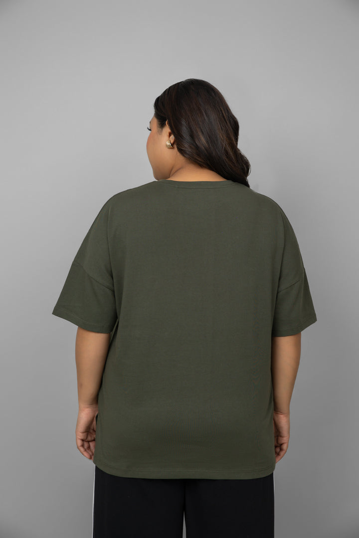 Back view of green top and black piping pants set.