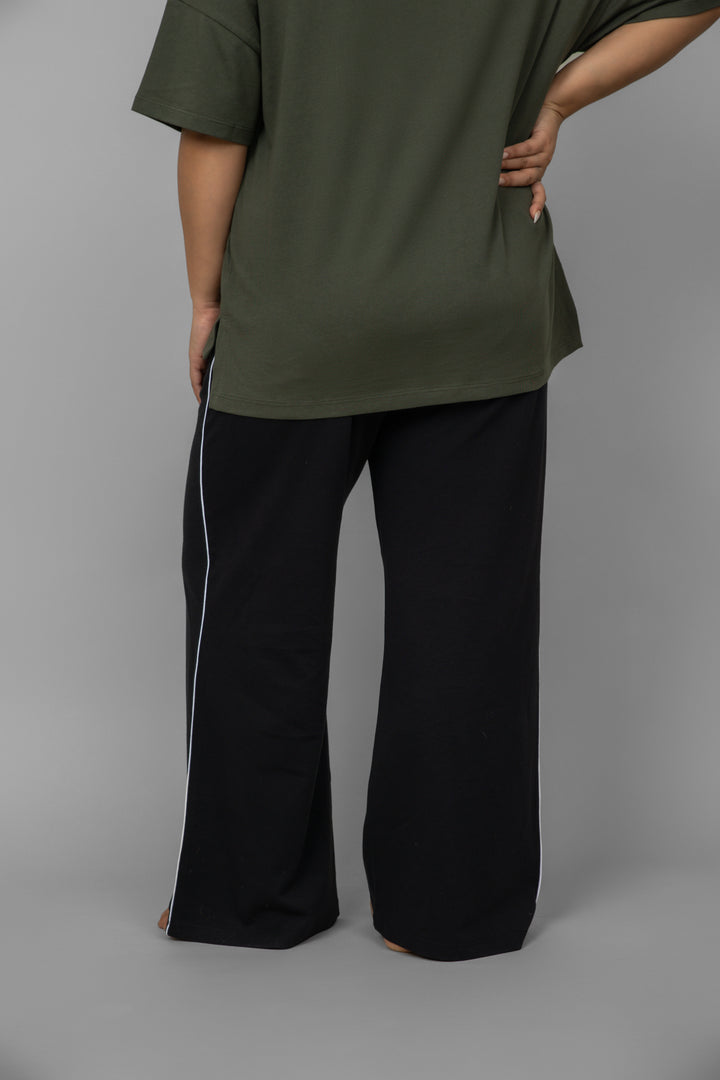 Green top with black piping pants set, stylish casual outfit.