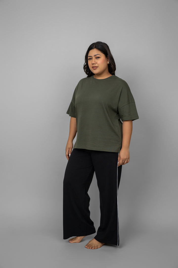 Black contrast piping pants styled with an olive green top.