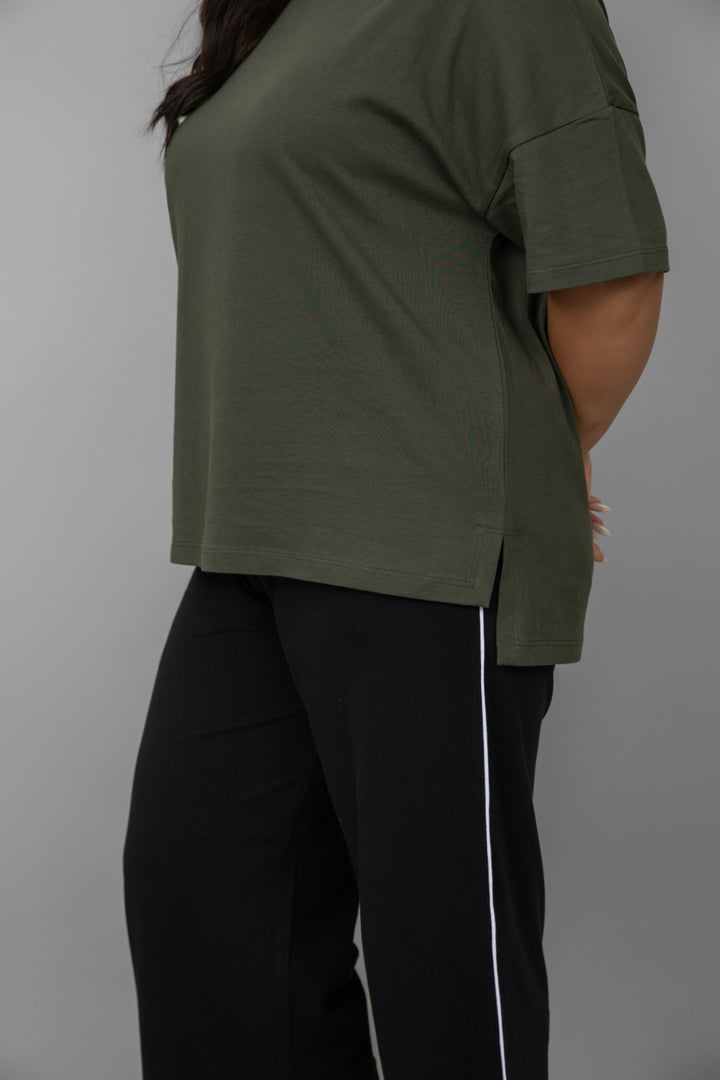 Black contrast piping pants styled with an olive green top.