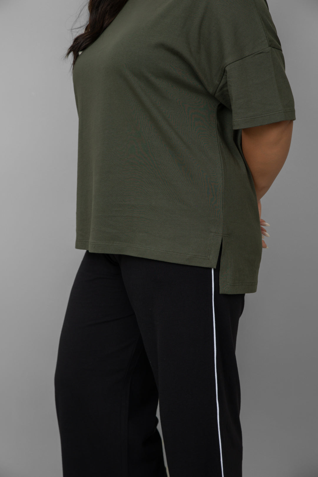 Green top with black piping pants set for casual wear.