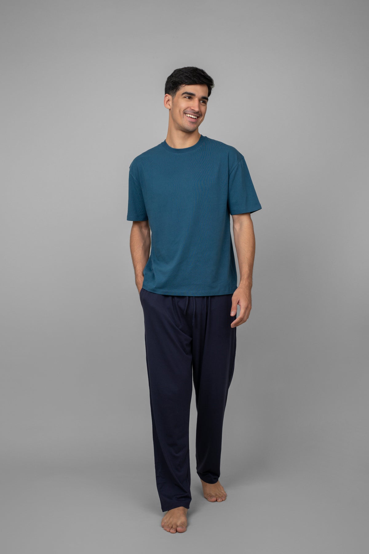 Blue men's essential t-shirt worn casually with comfortable pants.