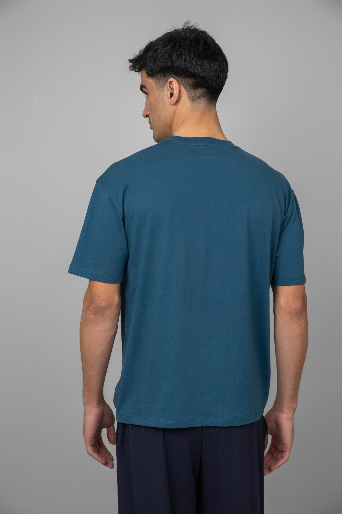 Blue men's essential T-shirt viewed from the back.