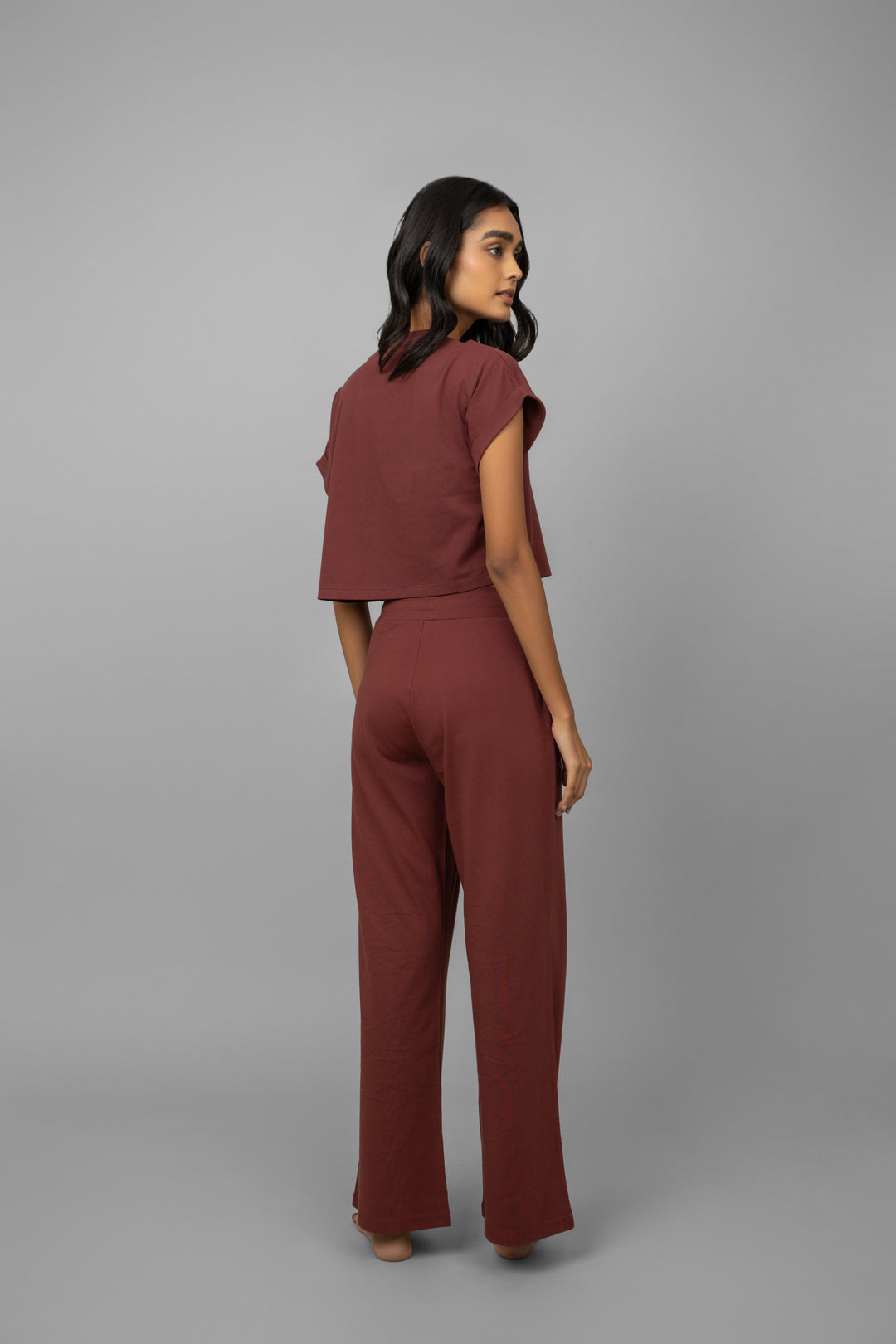 Model wearing a ruby crop top and matching pants.