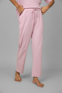Blush pink lounge pants with drawstring waist and pockets.
