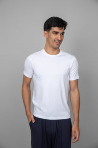 White men's essential t-shirt on model smiling in casual attire.