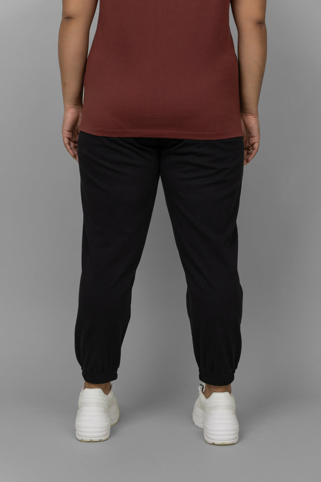 Black lounge joggers styled with a casual top and sneakers.