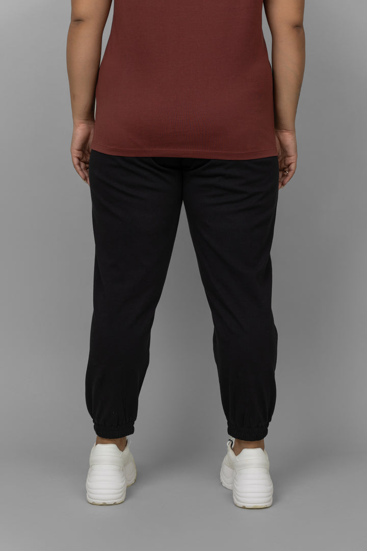 Black lounge joggers styled with a casual top and sneakers.