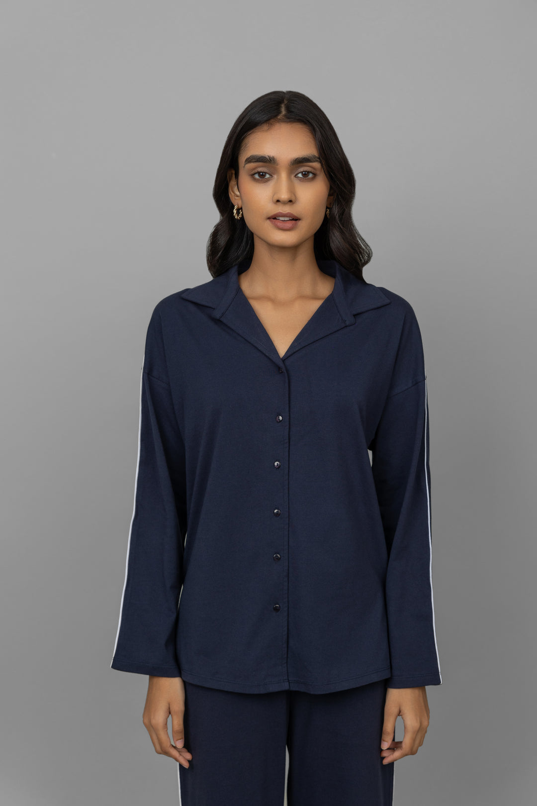 Navy button-down pajama set with white piping for women.