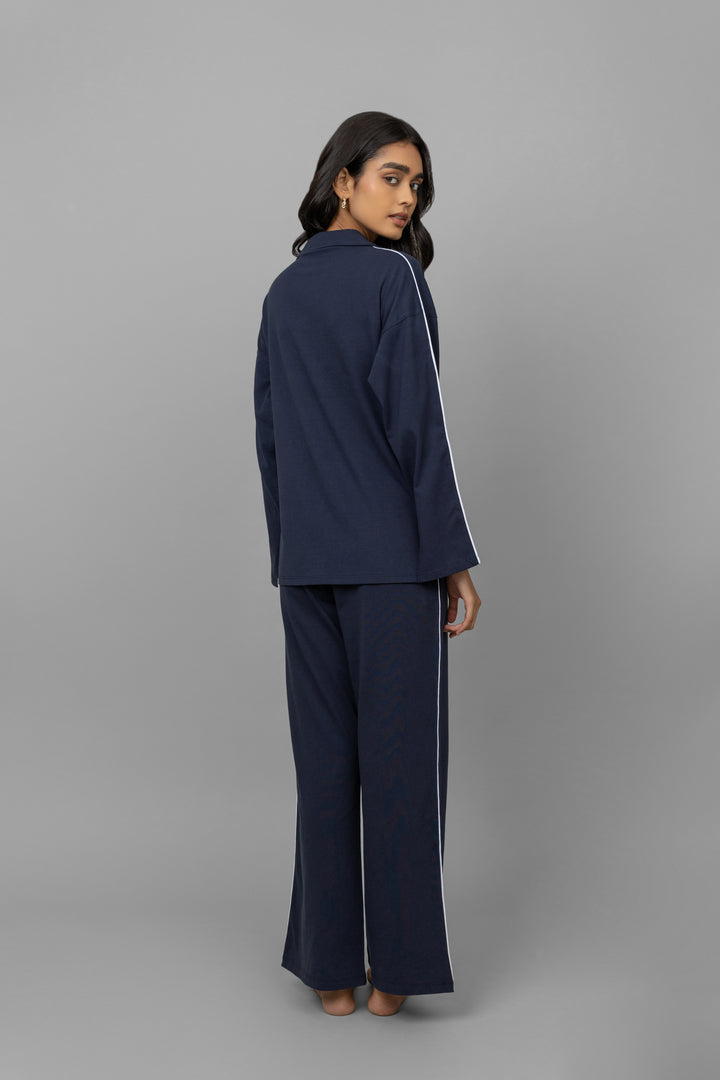 Navy button-down pajama set with white piping for stylish comfort.