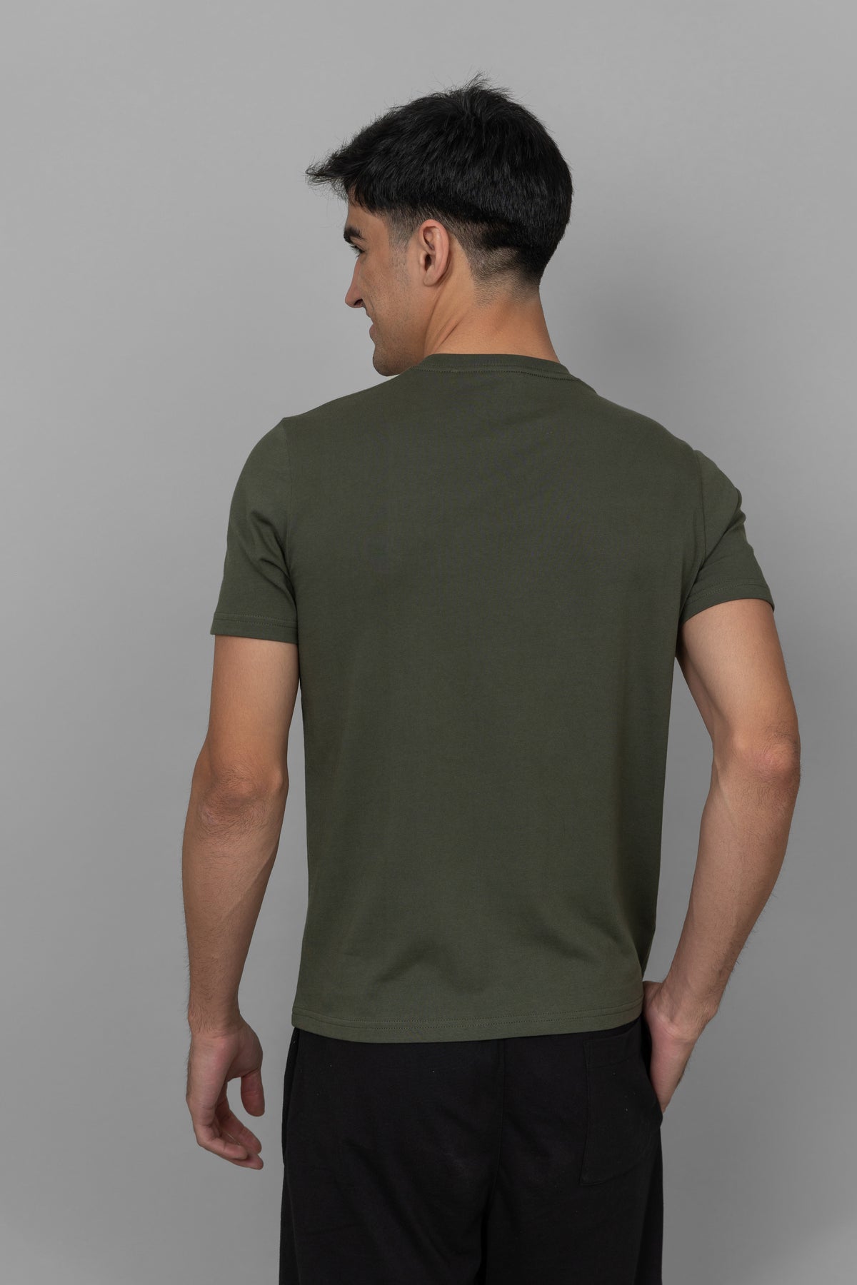 Back view of a green men's essential t-shirt.