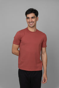 Rust Men's Essential T-shirt on a smiling model against a neutral background.