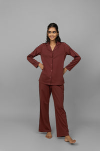 Ruby button-down piping pajama set worn by a smiling model.