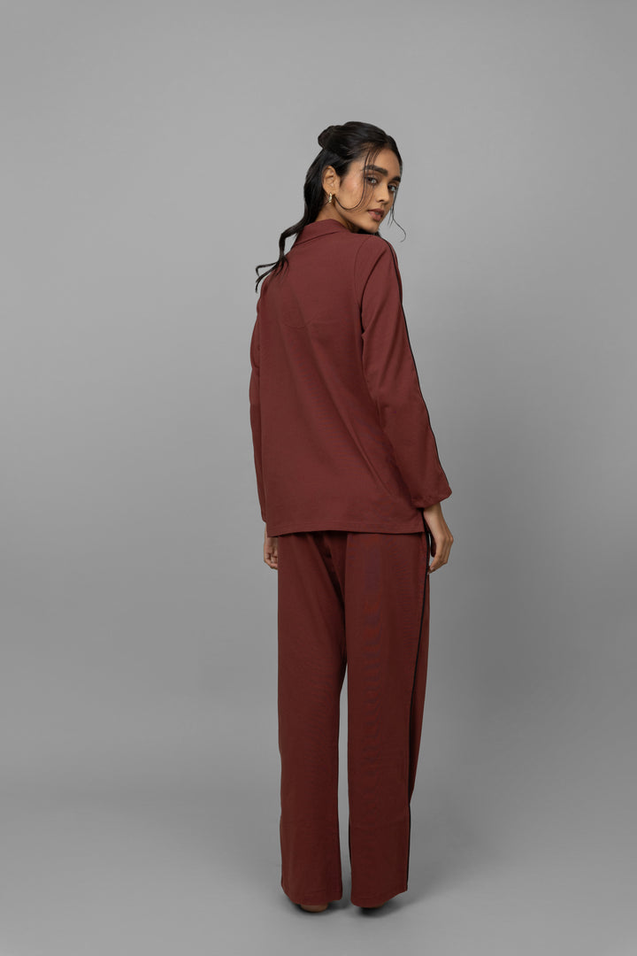 Model showcasing a ruby button down shirt, back view.