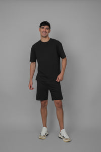 Black men's boxy shorts set with matching t-shirt. Stylish and comfortable outfit.