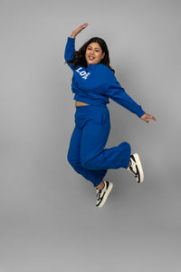 Model wearing Blue Bamboo Terry Travel Set, jumping in style.