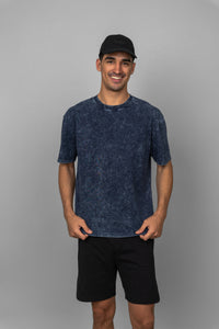 Navy acid wash unisex t-shirt model wearing casual outfit.