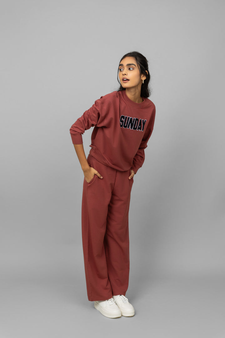 Stylish woman wearing Sunday Bamboo Terry Travel Set in earthy tones.