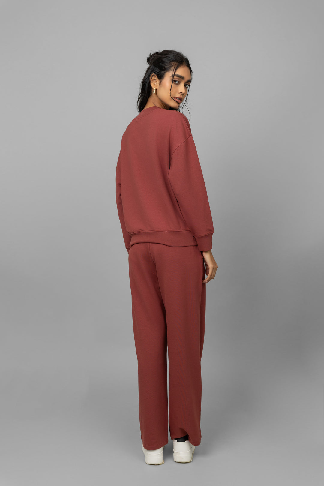 Model wearing Sunday Bamboo Terry Travel Set in rust color.
