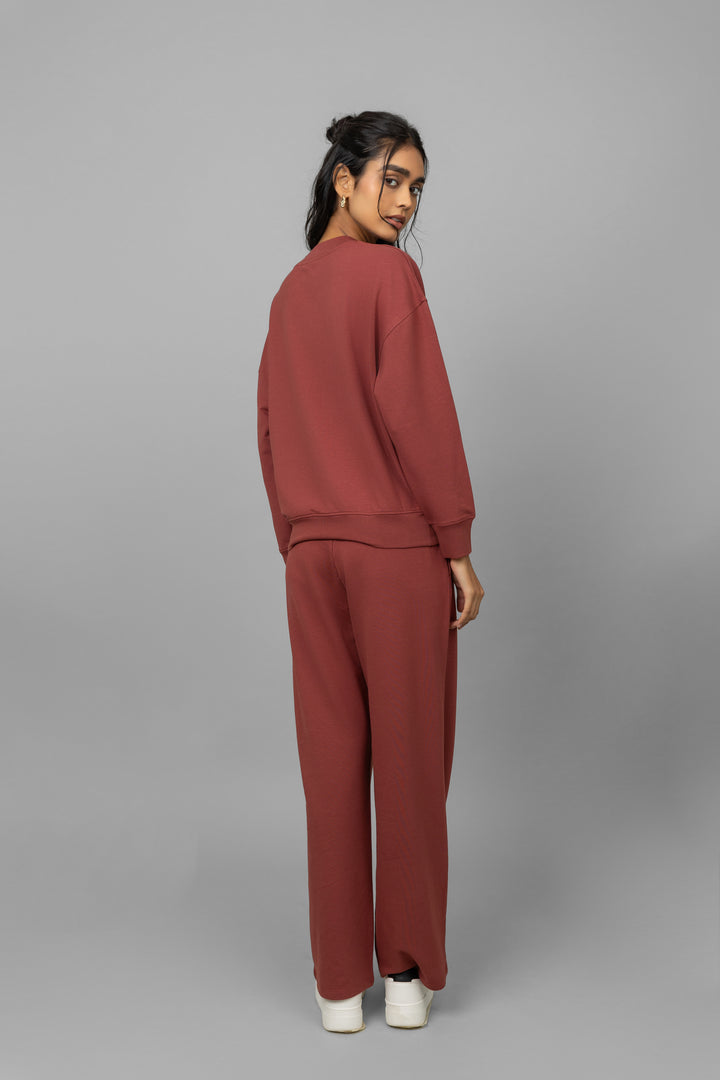Model wearing Sunday Bamboo Terry Travel Set in rust color.