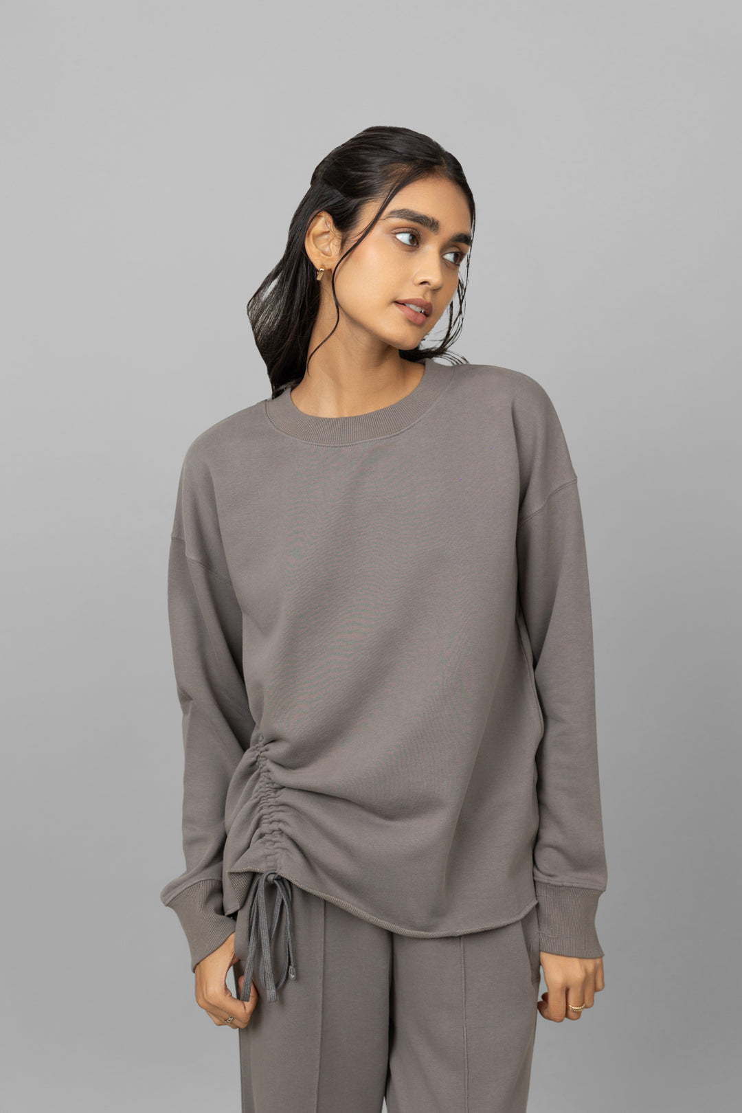 Stylish cotton terry sweatshirt with adjustable side ties for a trendy look.