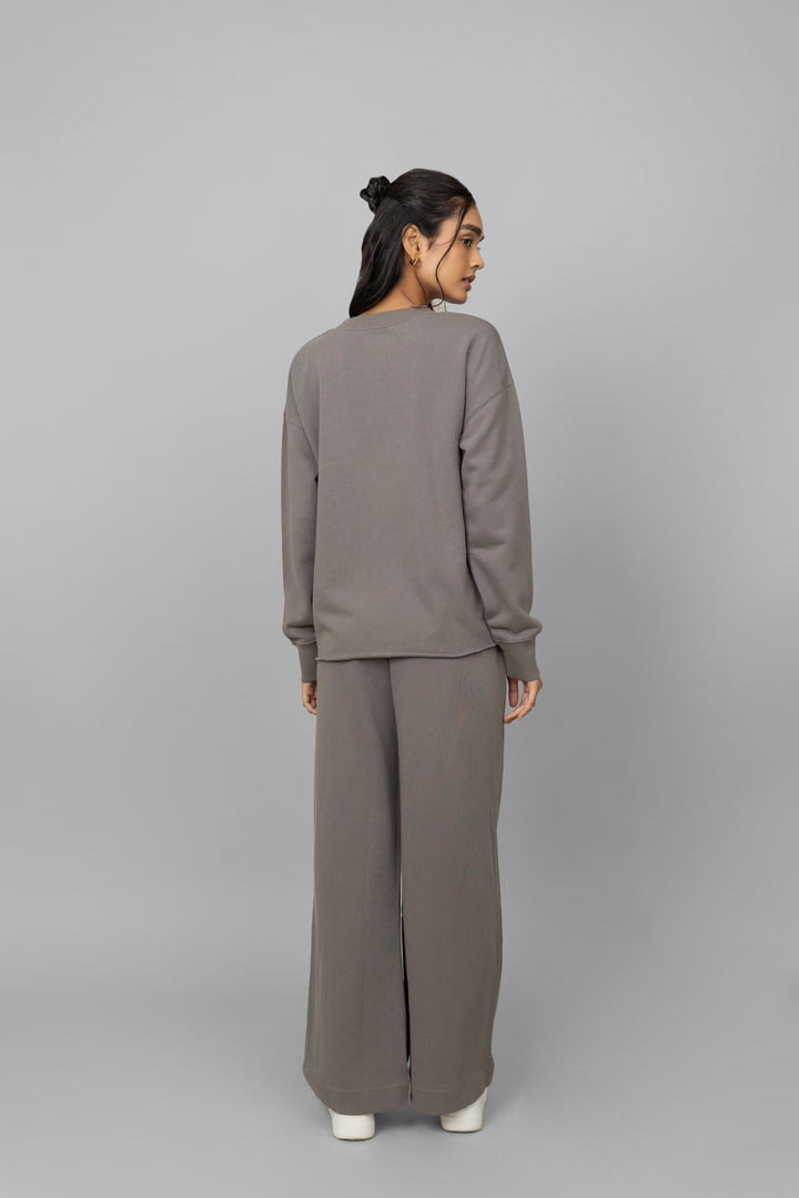 Grey terry ruched co-ord set worn by a model from behind.