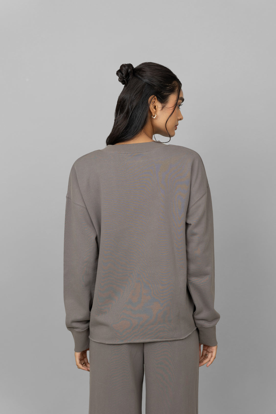 Back view of women's grey cotton terry sweatshirt.