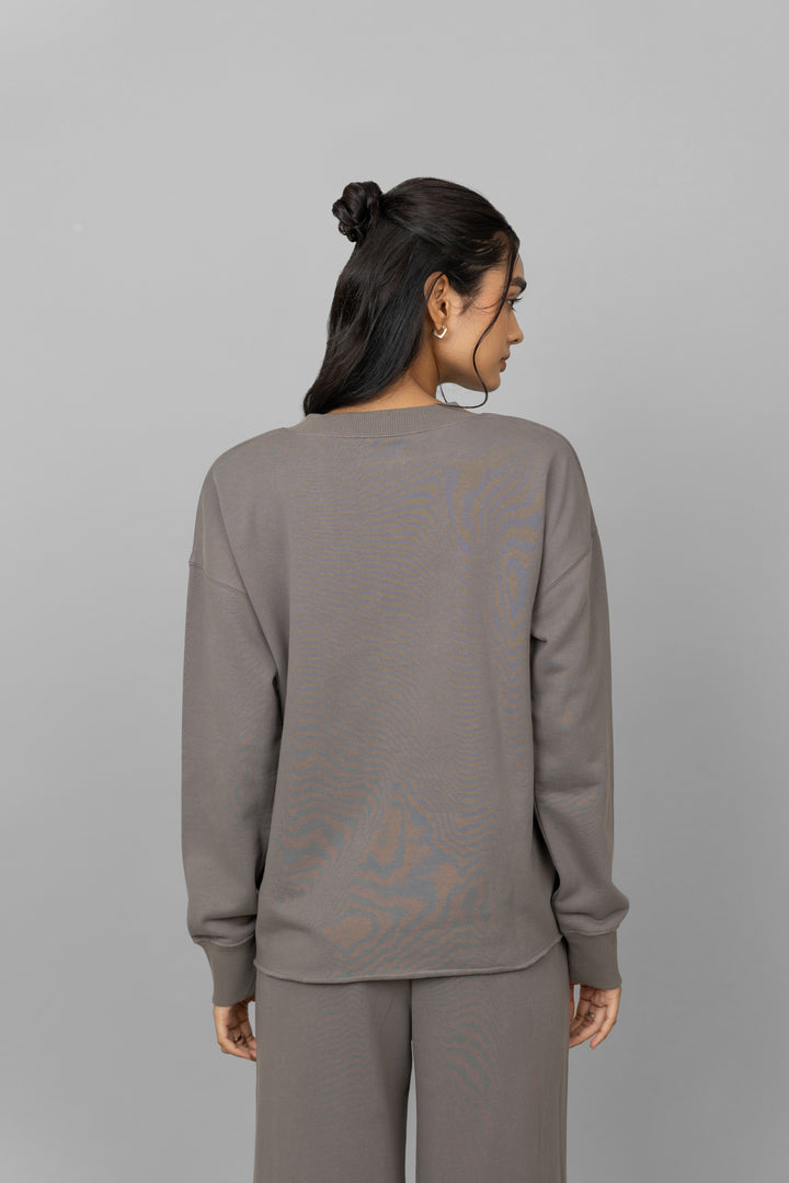 Back view of women's grey cotton terry sweatshirt.