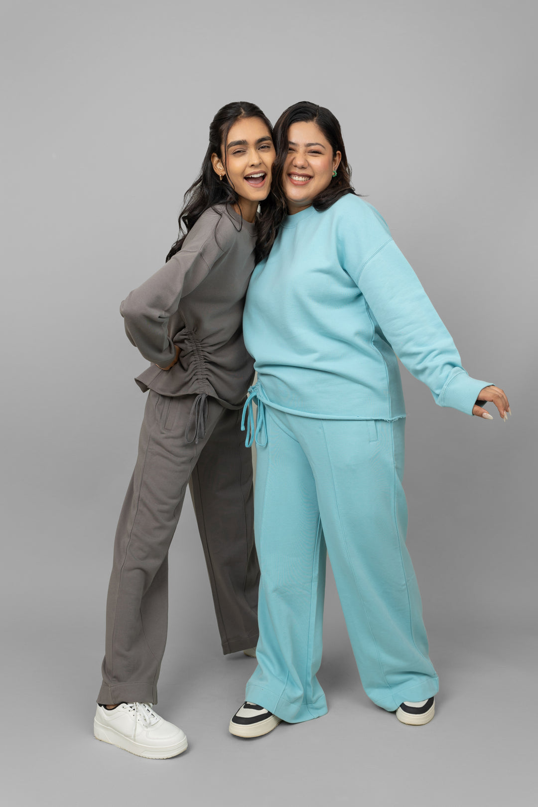 Two models wearing stylish cotton terry sweatshirts in different colors.