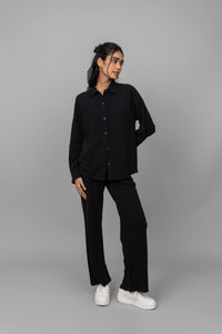 Black mini waffle pajama set for stylish comfort and relaxation.