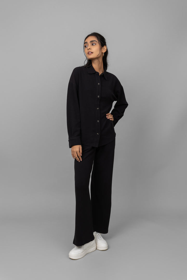 Black mini waffle pajama set modeled with stylish white sneakers.