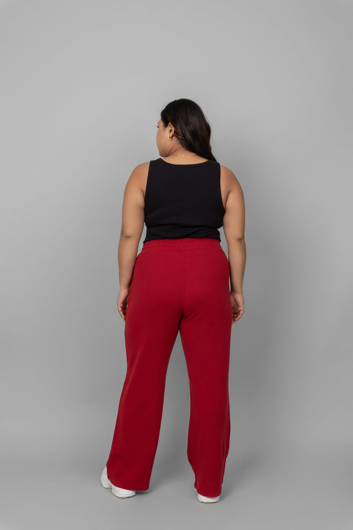 Back view of a model wearing red Mini Waffle MultiTask Pants.