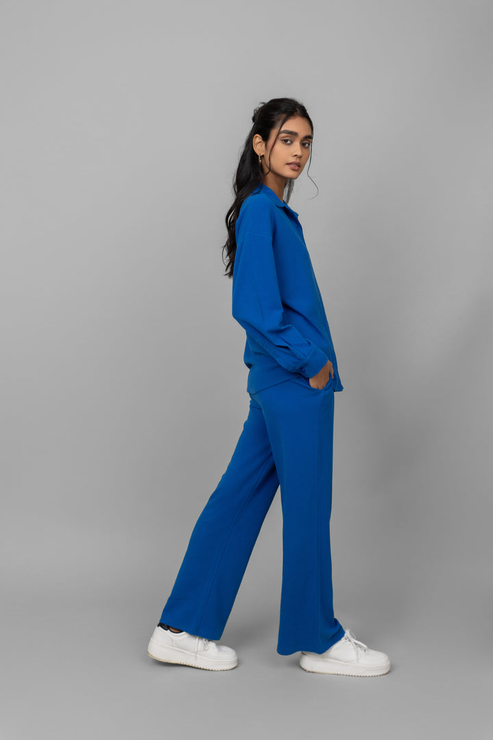 Blue Mini Waffle MultiTask Pants modeled by a woman in stylish pose.