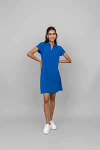 Model wearing a blue mini waffle short polo dress with sneakers.